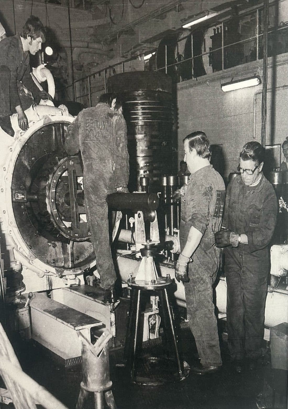Archive photograph of the FG team overhauling a large turbocharger in the workshop